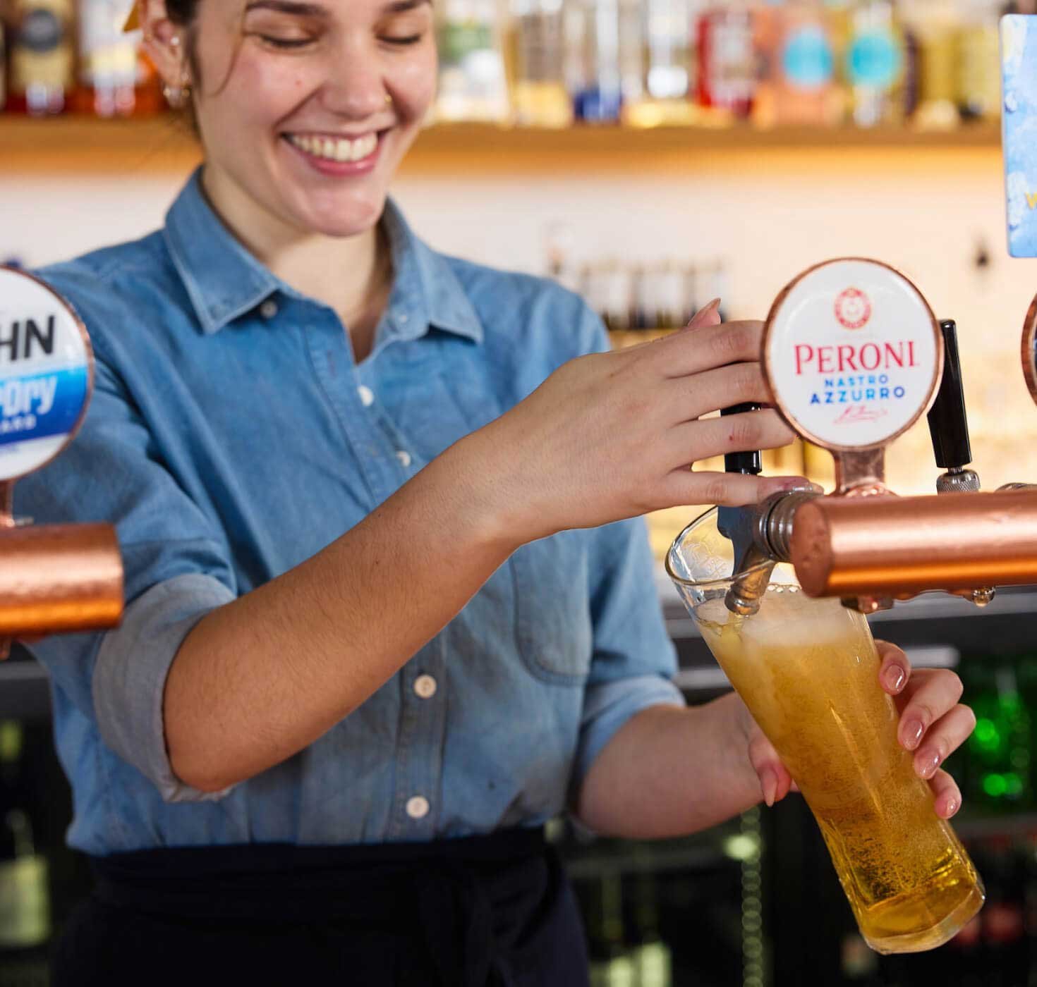 bar staff pulling a pint of beer